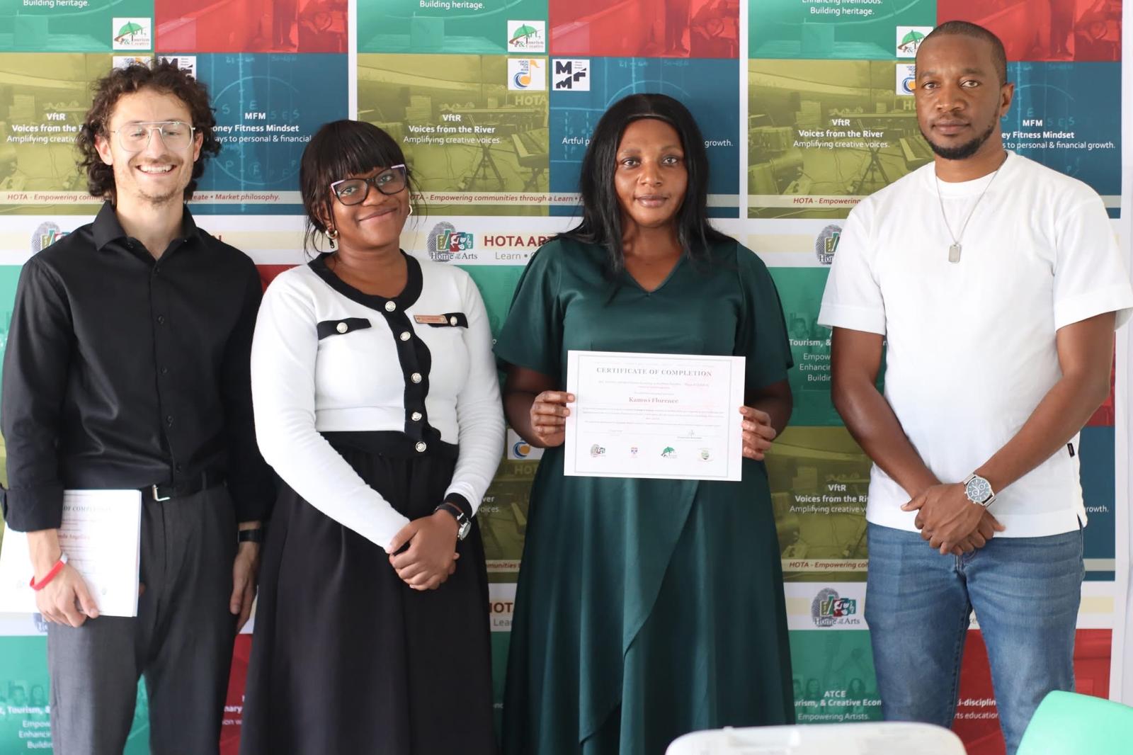 A teacher receiving a certificate of completion for the ATCE-II training